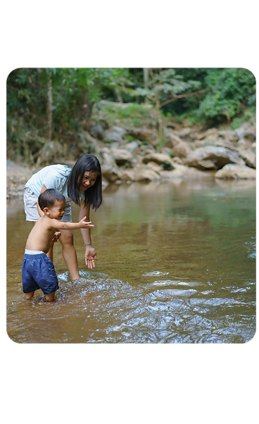 A parent and child beside a river